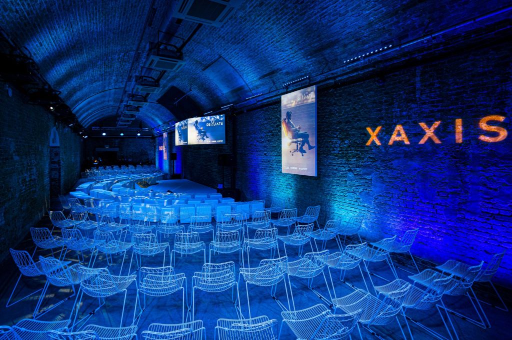 Creative conference plenary space in tunnel with projection mapped wall branding