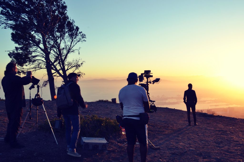 Silhouetted film crew at lookout point in South Africa, shooting Inmarsat 40th Anniversary communications film